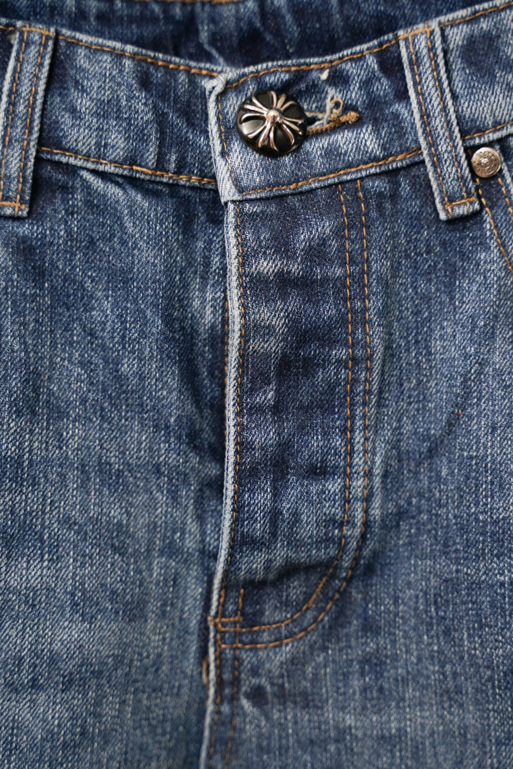 Chrome denim pants close-up of button fly and stitched waistband