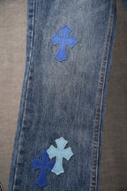 Chrome denim pants with blue cross patches on front leg