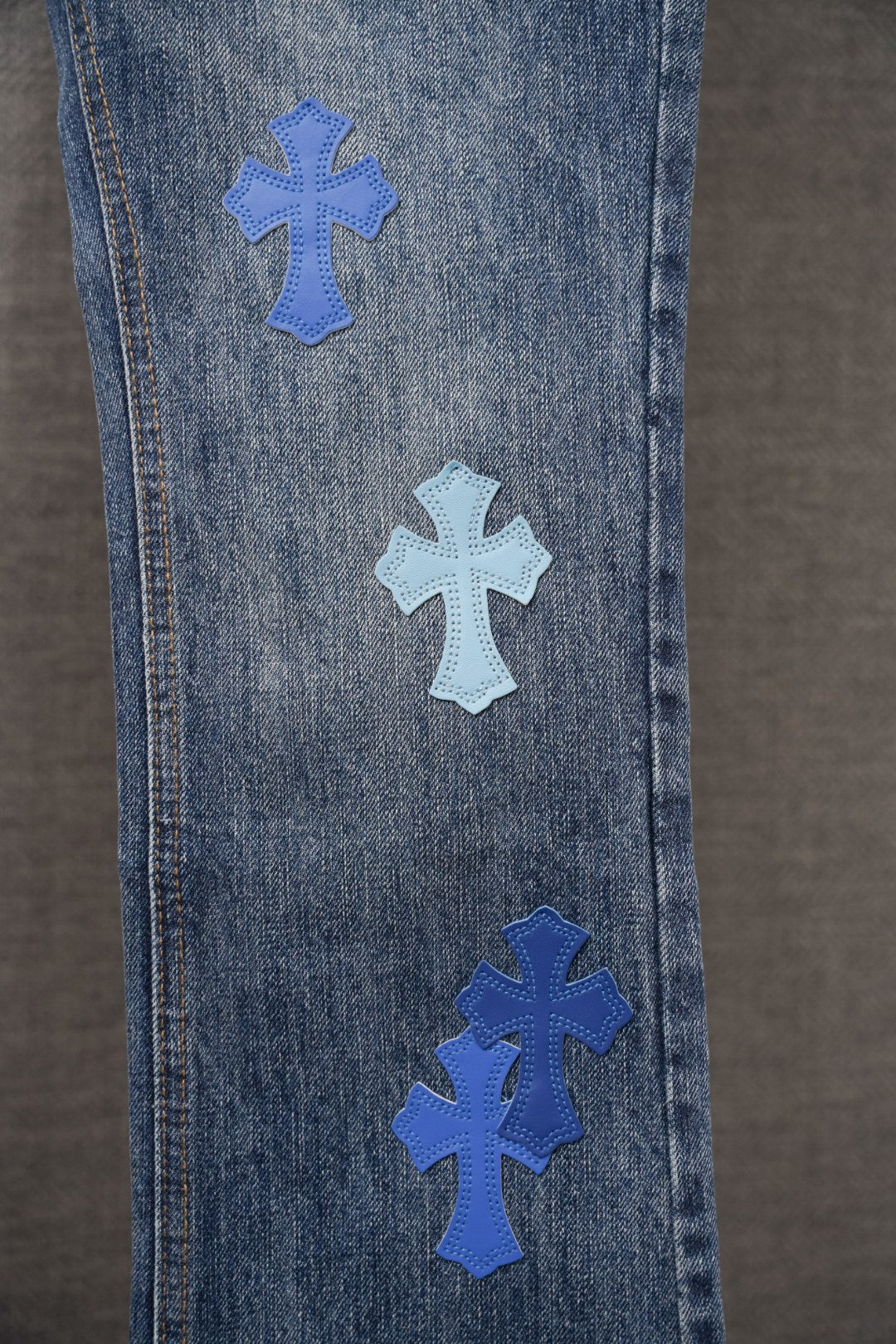 Chrome denim pants with blue cross patches along side panel