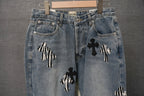 Light blue denim pants with black and white cross patches on both legs