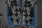 Light-wash denim jeans with dense black cross and striped appliqué cluster