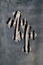 Light blue denim pants with oversized striped graphic print on front leg