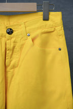 Chrome pants in bright yellow with multiple front pockets and belt loops.