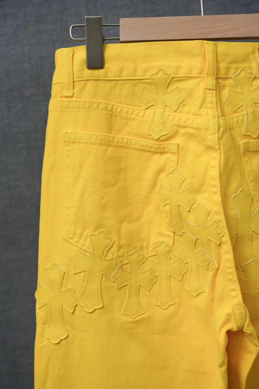 Chrome pants in bright yellow with textured star-like applique across the front.