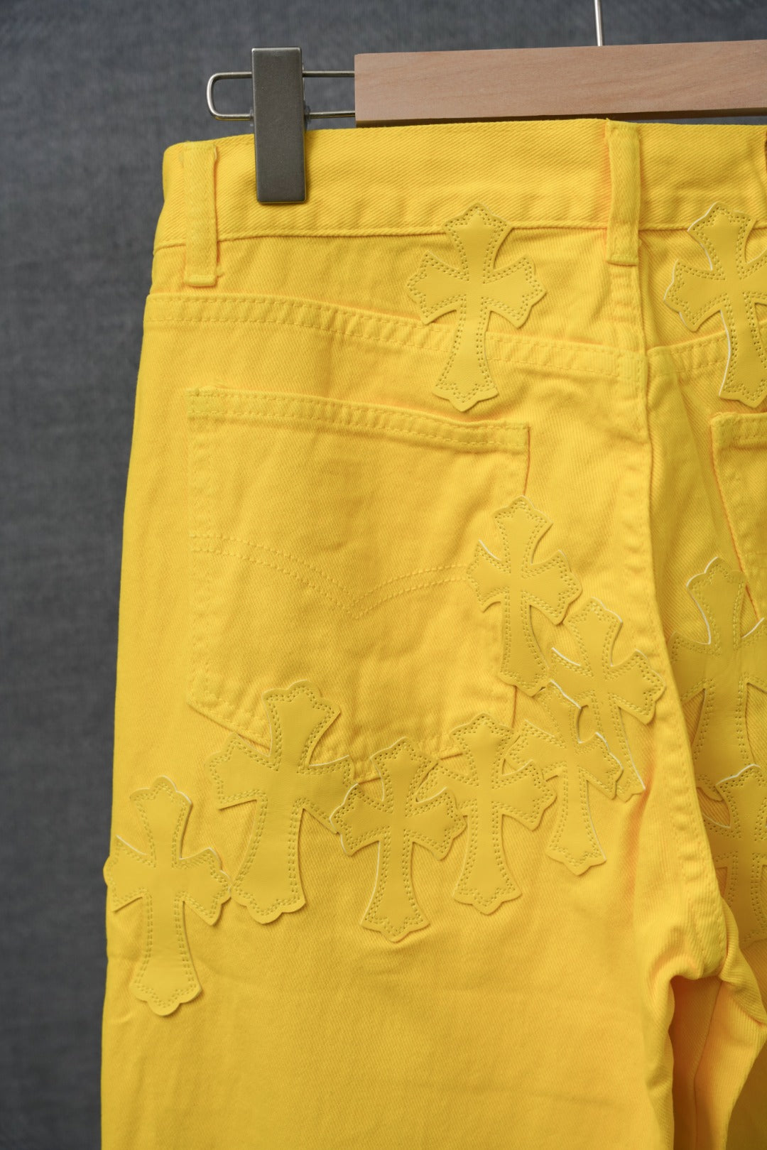 Chrome pants in bright yellow with textured star-like applique across the front.