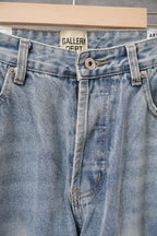 Light-wash denim jeans with button fly, belt loops, and stitched front seams