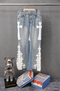 Light-wash denim pants with white cross appliques along both legs