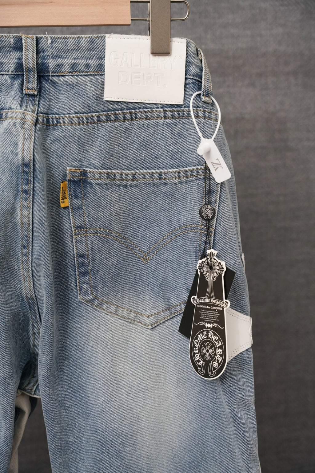 Light blue denim pants with front pocket, waist tag, and keychain charm