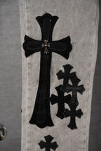 Light-wash denim pants with tall black cross applique and smaller cross patches