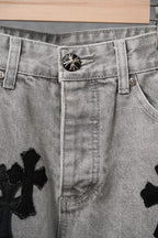 Light-wash denim pants close-up of button waist and belt loops