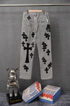 Light gray denim pants with black cross patches, side view; button and zipper fly.