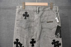 Light gray denim pants back view with black cross patches and dual pockets.