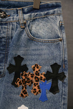 Back pocket area of light blue denim pants with cross appliques