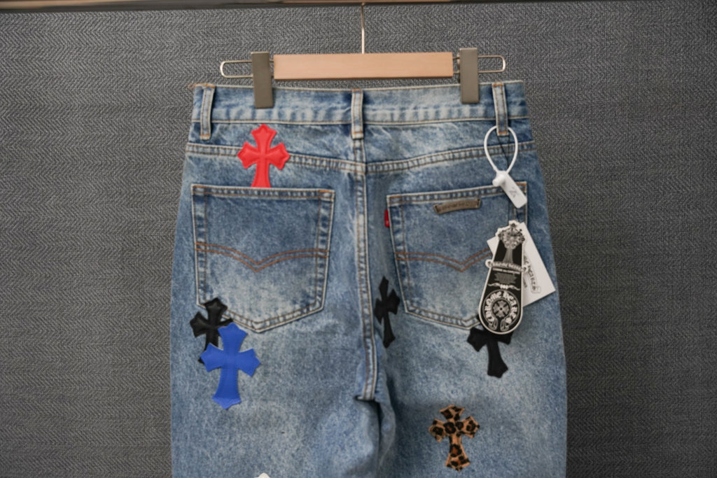 Blue denim pants with multiple cross patches and hanging hangtag