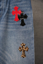Light blue denim pants vertical cross patches: red with black, leopard-print below