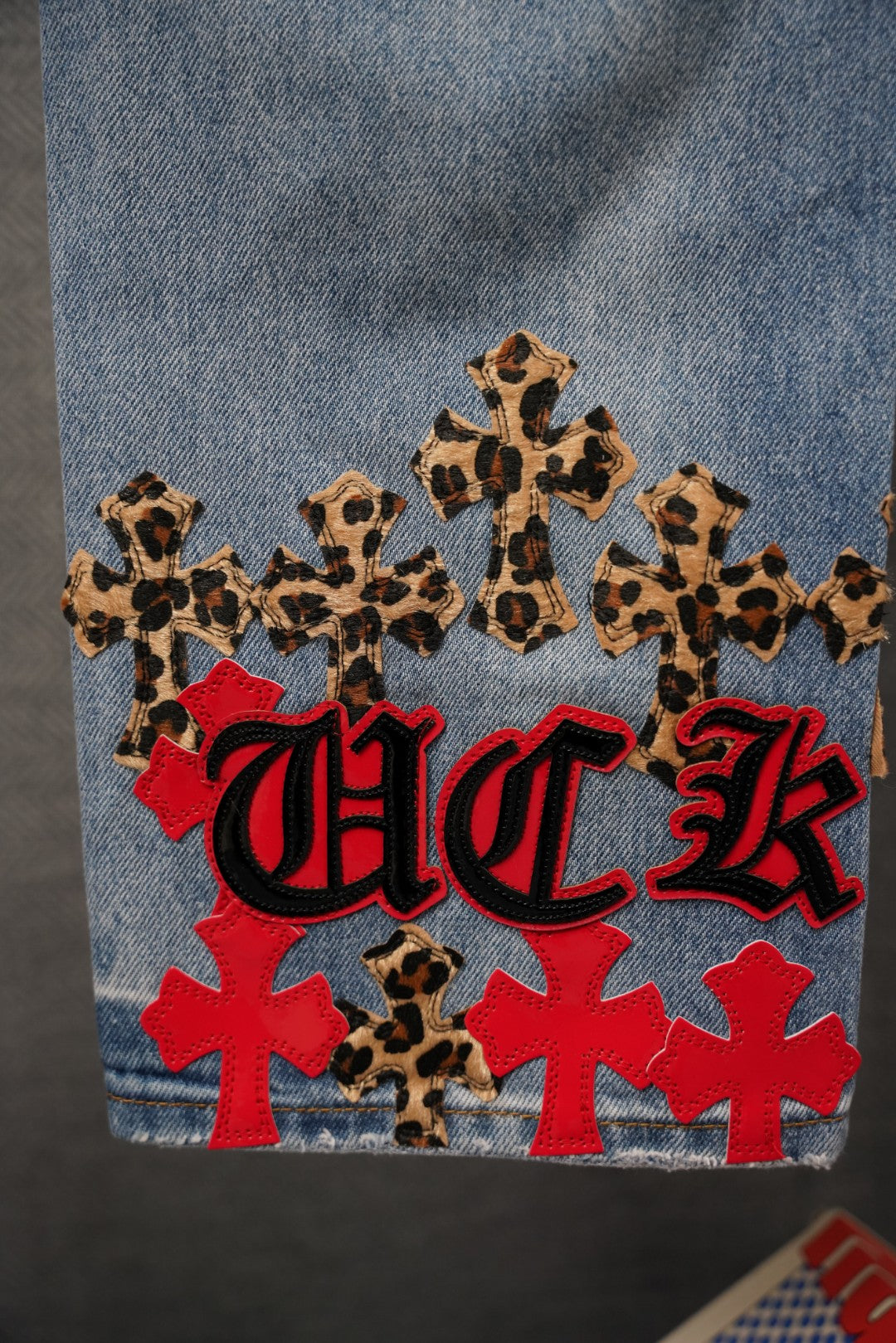 Chrome pants denim back with leopard print, red crosses, and Chrome-style lettering