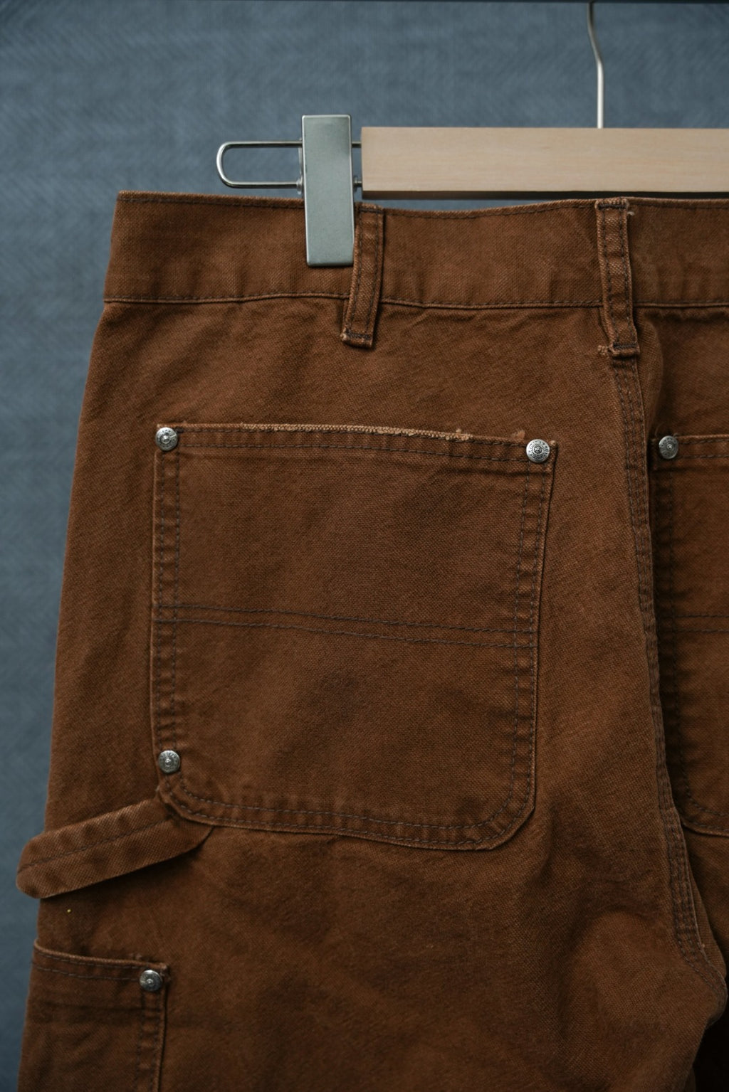 Chrome brown pants with waistband, belt loops, and large front patch pocket