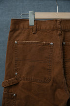 Chrome brown pants with waistband, belt loops, and large front patch pocket