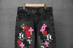 Black denim Chrome pants with front graphic crosses and cartoon face patch