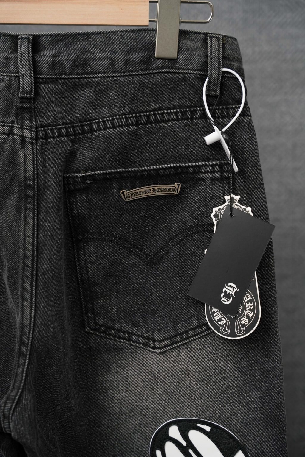 Chrome pants, dark denim front with logo patch and hanging keychain tag