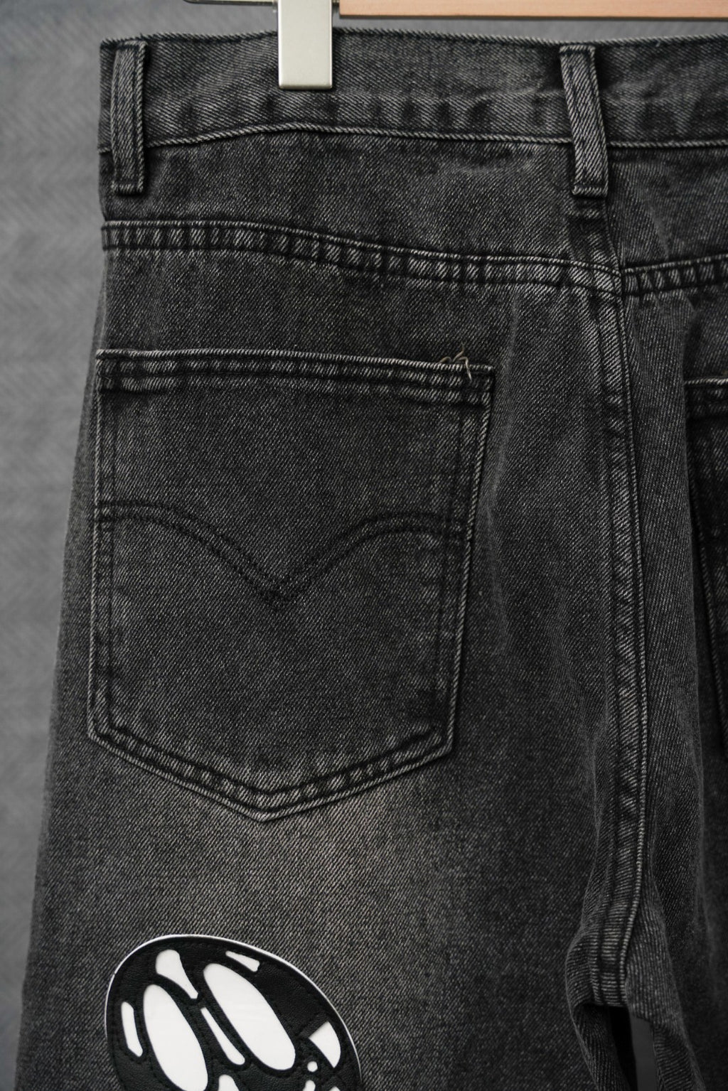 Black denim pants close-up of front pocket and belt loops