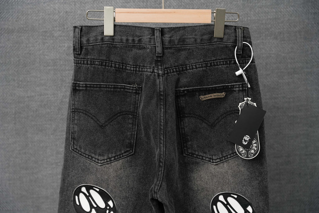 Black denim pants with front pockets and hanging tag