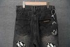 Black denim pants with front pockets and hanging tag