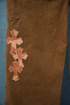 Brown chrome pants leg with stacked orange cross patches