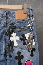 Blue denim pants with star and cross appliqués, keychain, and hang tag