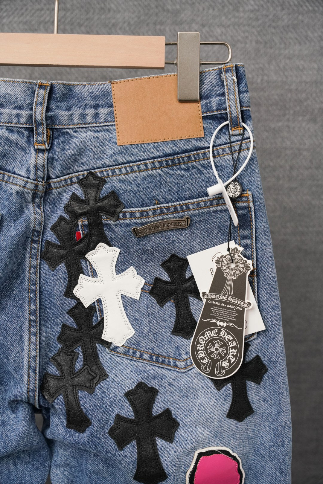 Chrome pants, light blue denim with multiple cross patches and hanging tag details