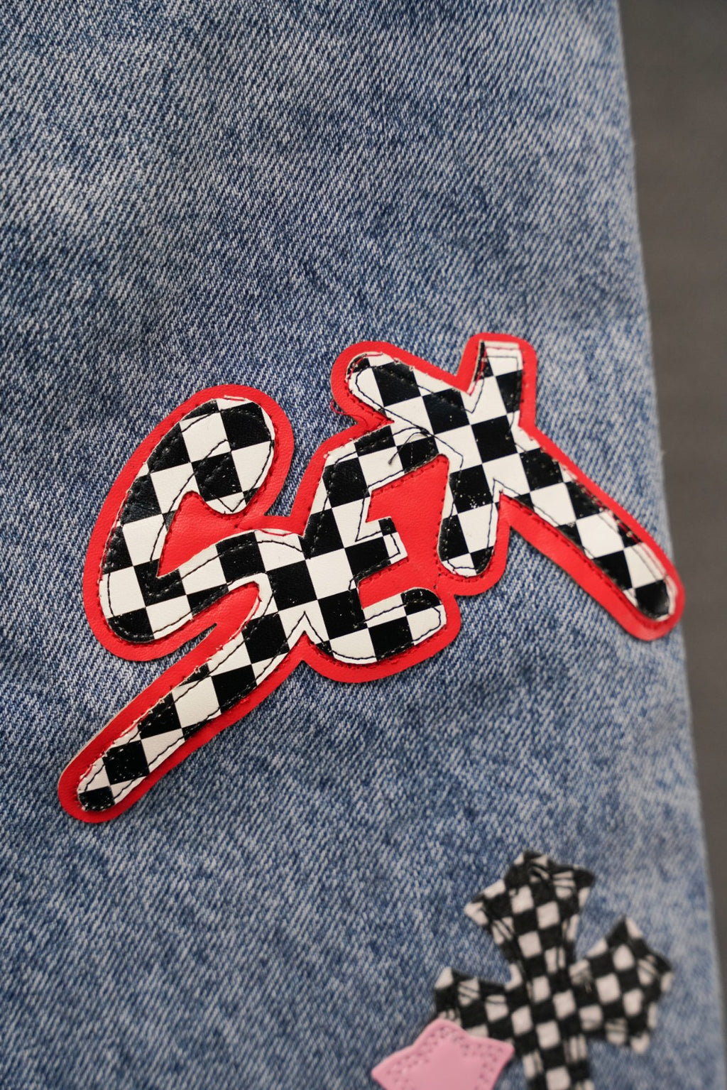 Chrome pants, light blue denim with checker graphic cross and small patch details