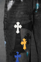 Dark denim pant front with large white cross and colored cross patches