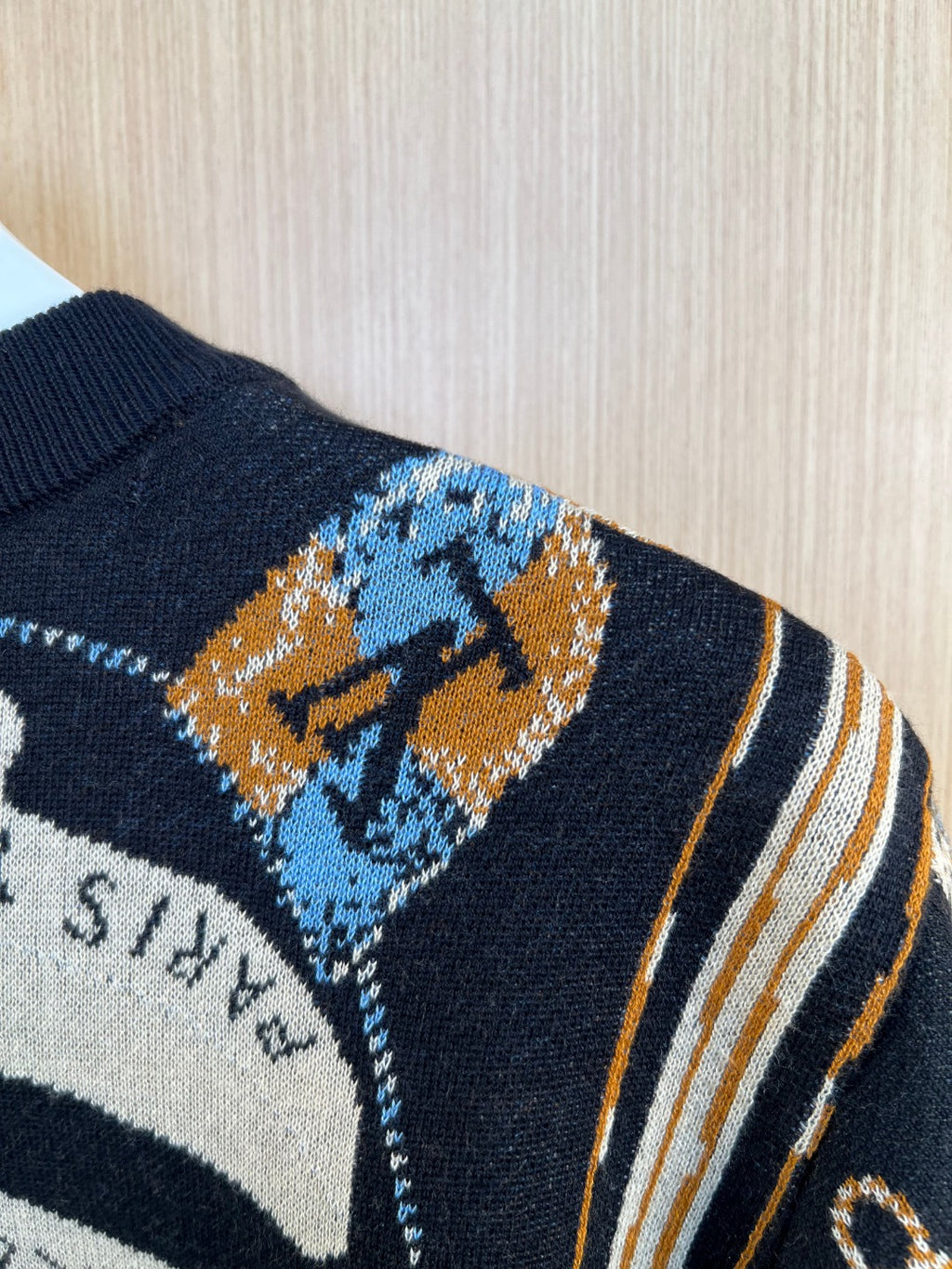 Louis Vuitton knit sleeve with navy, blue, and orange abstract motif and striped trim