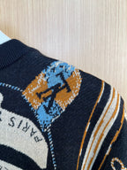 Louis Vuitton knit sleeve with navy, blue, and orange abstract motif and striped trim
