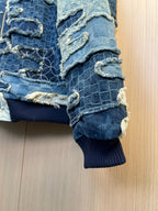 Patchwork denim jacket sleeve detail with rib knit cuff and frayed seams