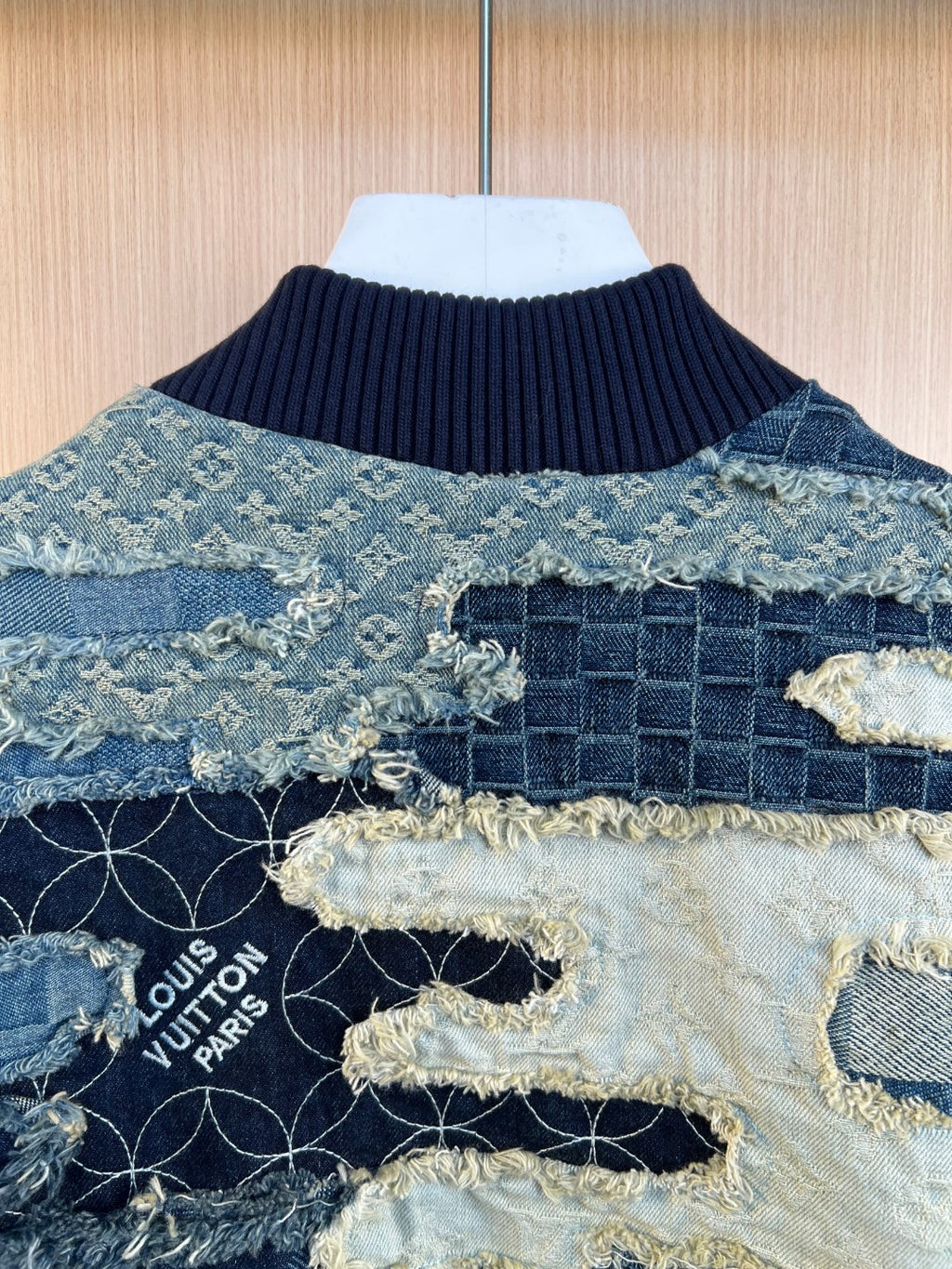 Louis Vuitton logo patch on patchwork denim jacket with frayed collar trim