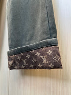 Pant cuff with dark fabric and Louis Vuitton monogram trim at the hem