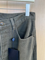 Waistband detail with belt loop, button closure, and front pocket with hanging tag