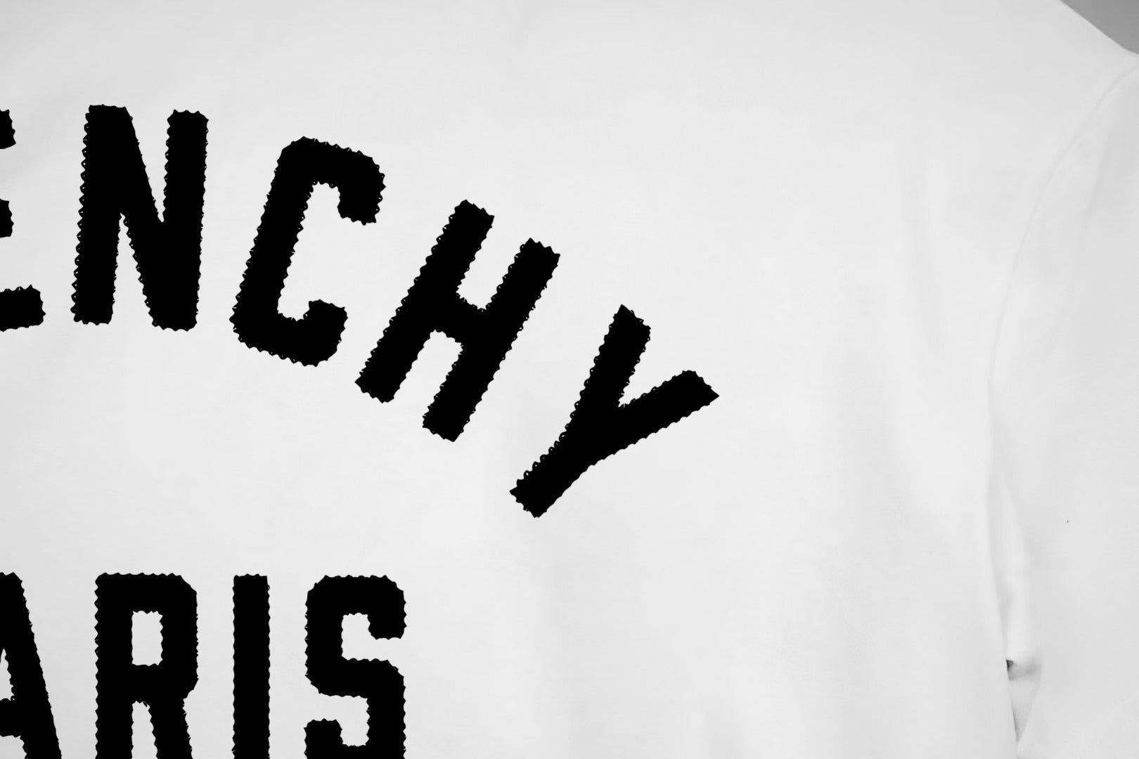 White T-shirt chest close-up of Givenchy Paris lettering