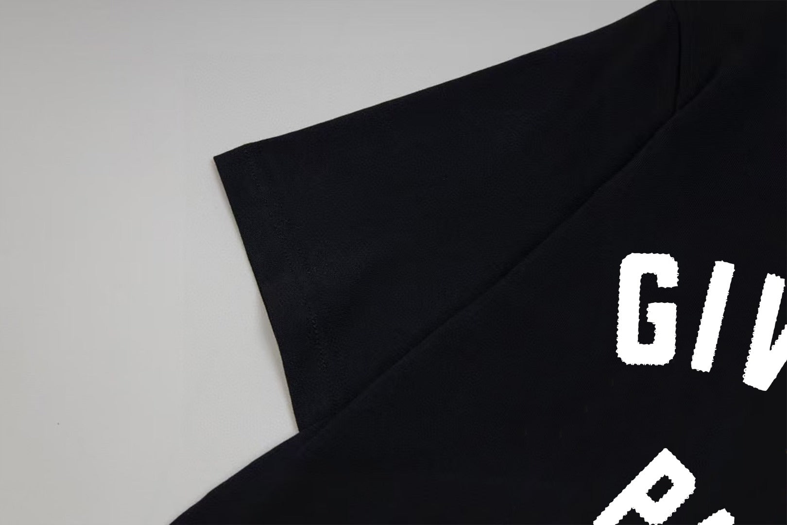 Givenchy Paris logo T-shirt detail, white lettering on black fabric
