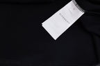 Black T-shirt with white GIVENCHY size tag near neckline