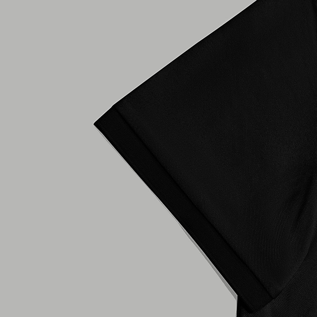 Black polo shirt sleeve and shoulder seam detail