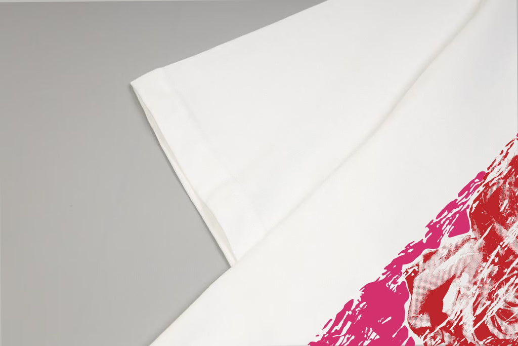 White T-shirt fabric fold with red/pink graphic edge visible