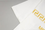 White T-shirt sleeve cuff with gold geometric logo print detail.