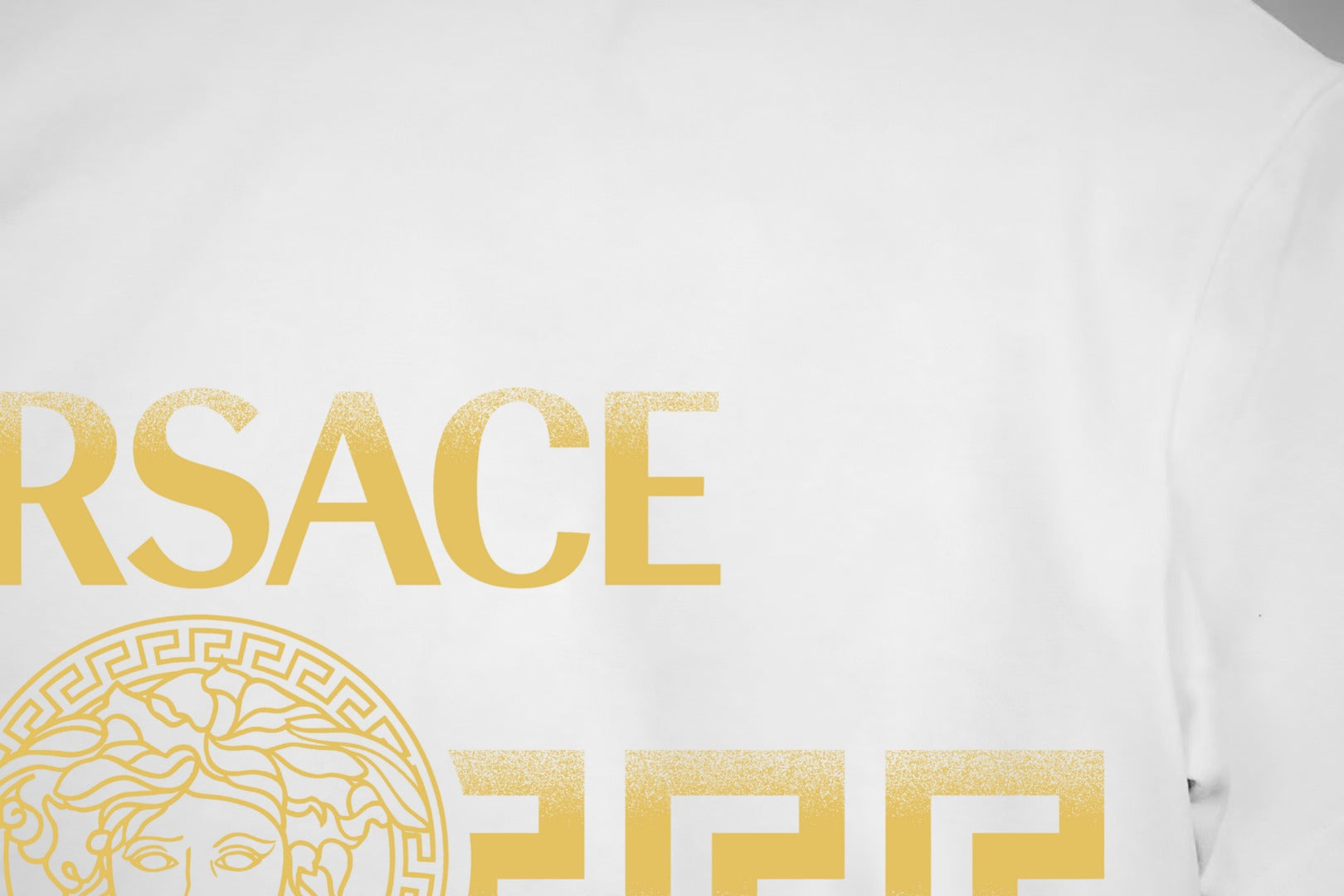 White T-shirt chest print with partial gold VERSACE text and logo.