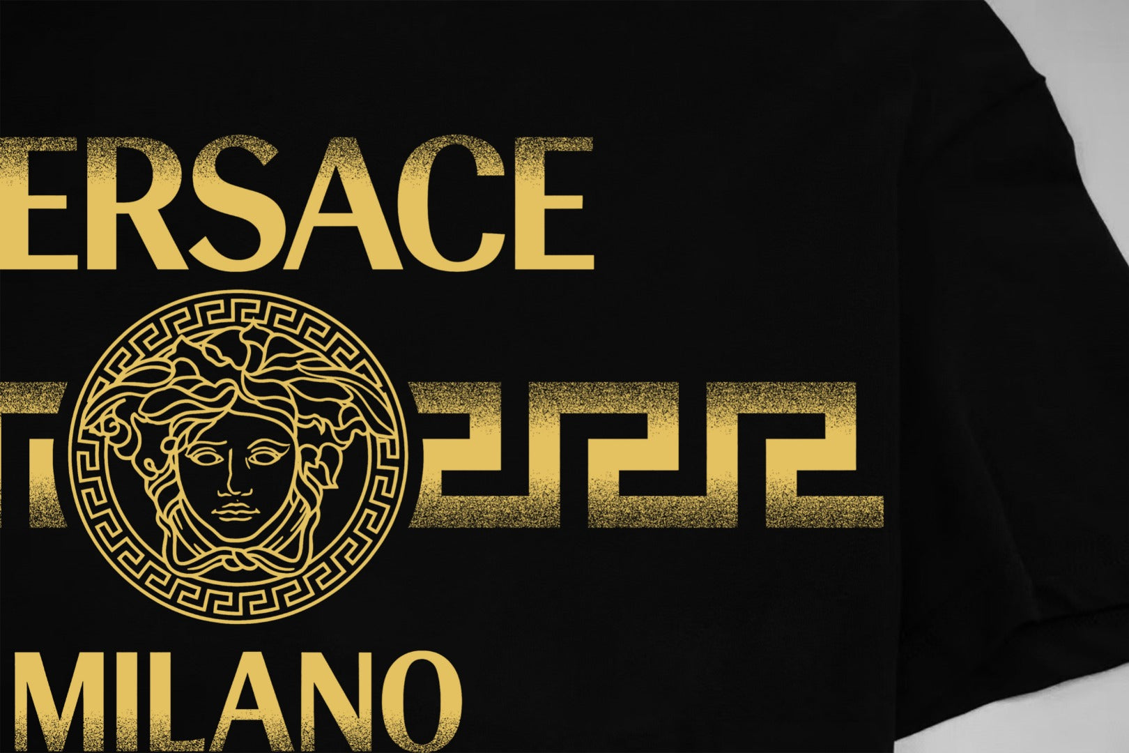 Black Versace T-shirt close-up of gold VERSACE MILANO logo