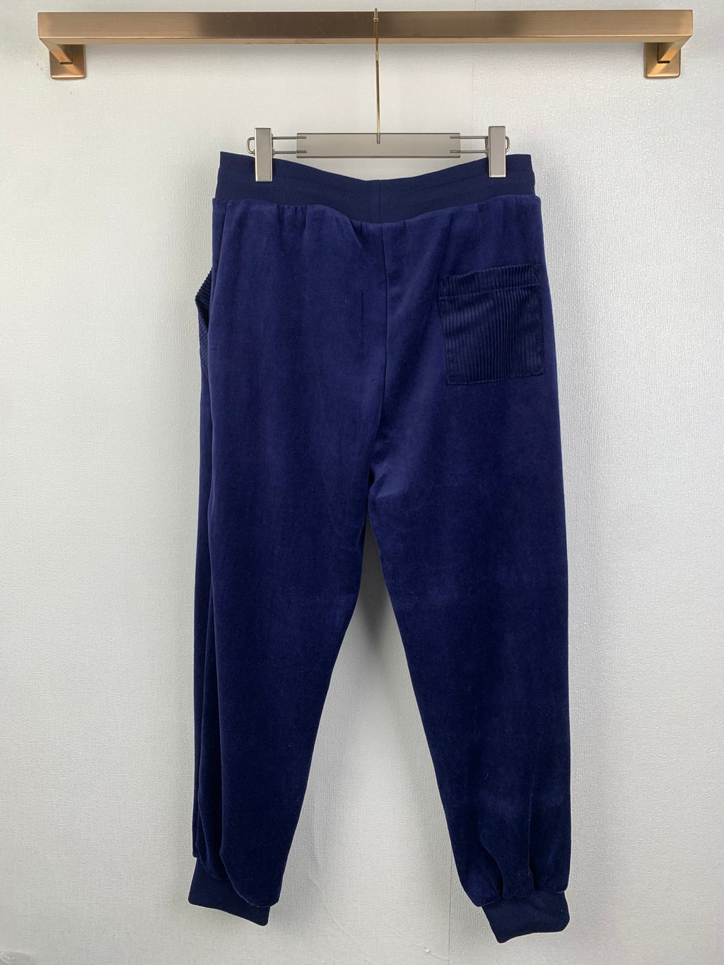 Dark blue jogger pants with elastic waistband and relaxed tapered legs