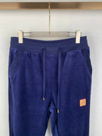 Dark blue sweatpants with drawstring, patch label, and elastic cuffs