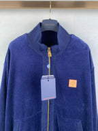 Blue Louis Vuitton zip-up jacket front view with logo patch and stand collar