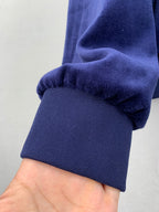 Blue Louis Vuitton jacket cuff and hem detail with ribbed knit trim